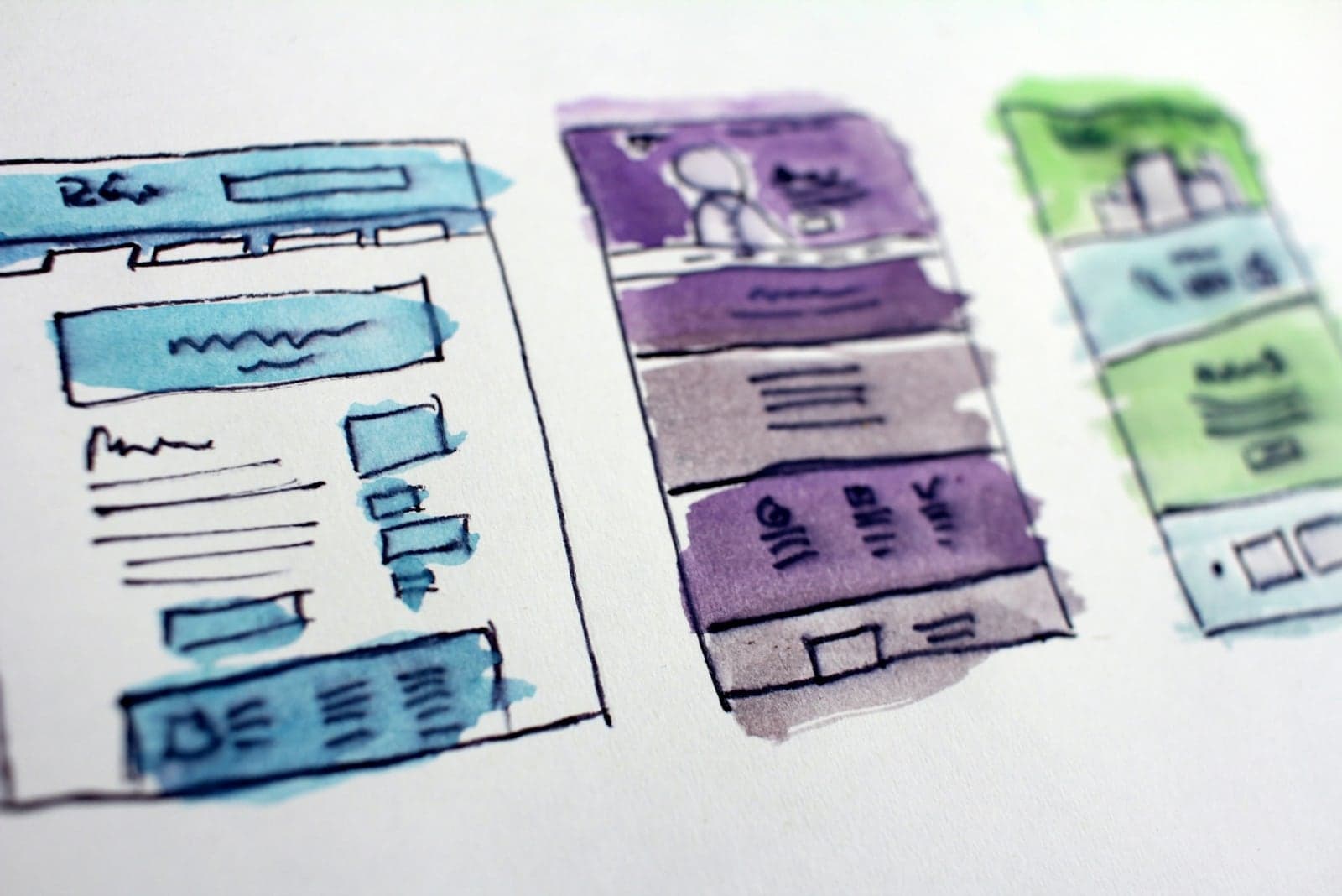 Hand-drawn website and mobile wireframes for structured content planning.